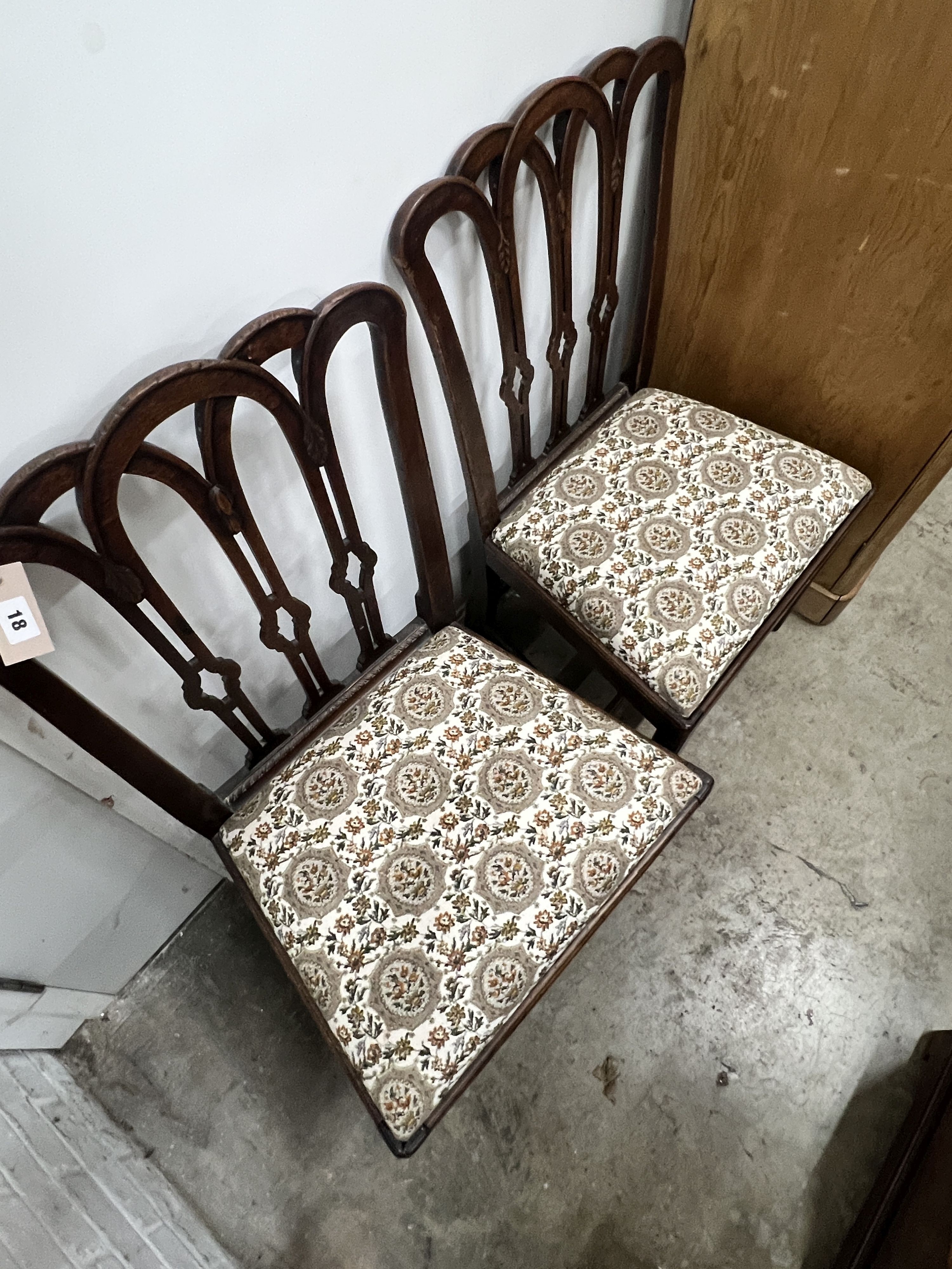 A pair of Georgian mahogany dining chairs, with pierced splats and drop-in seats on square legs